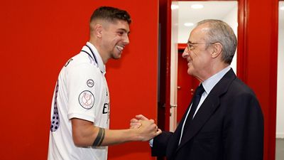 The president congratulates the champions in the dressing room
