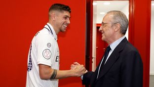 The president congratulates the champions in the dressing room